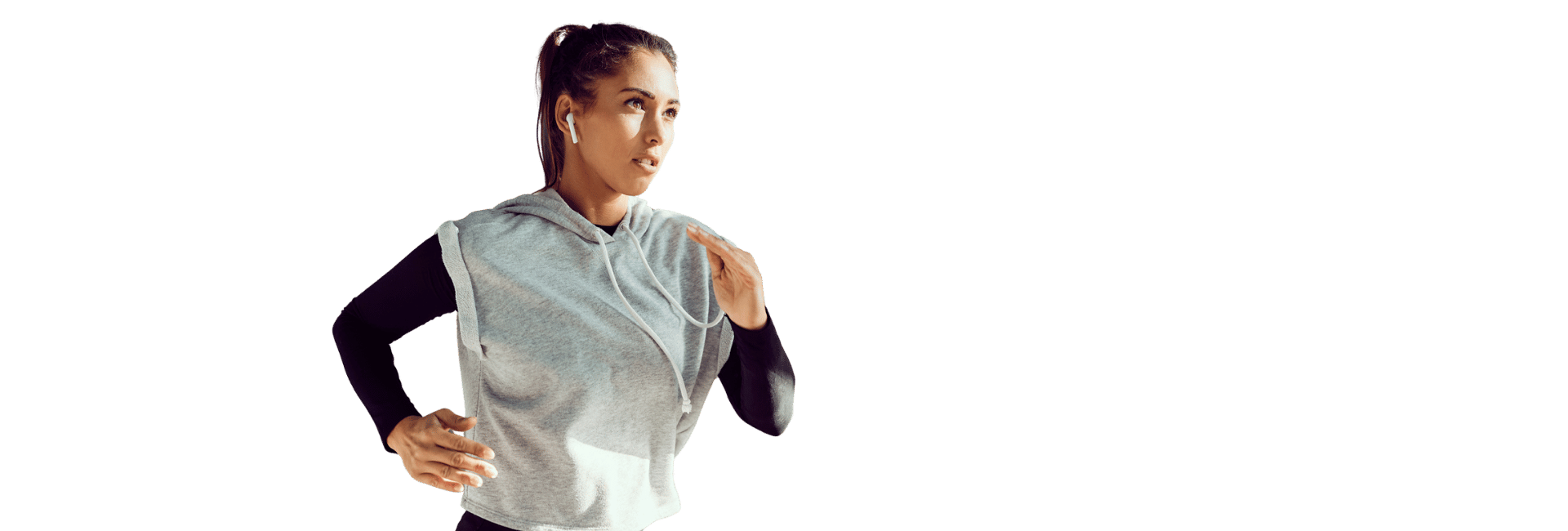 Woman in athletic gear running with wireless earbuds, representing cardio fitness at Women’s Fitness Clubs of Canada.